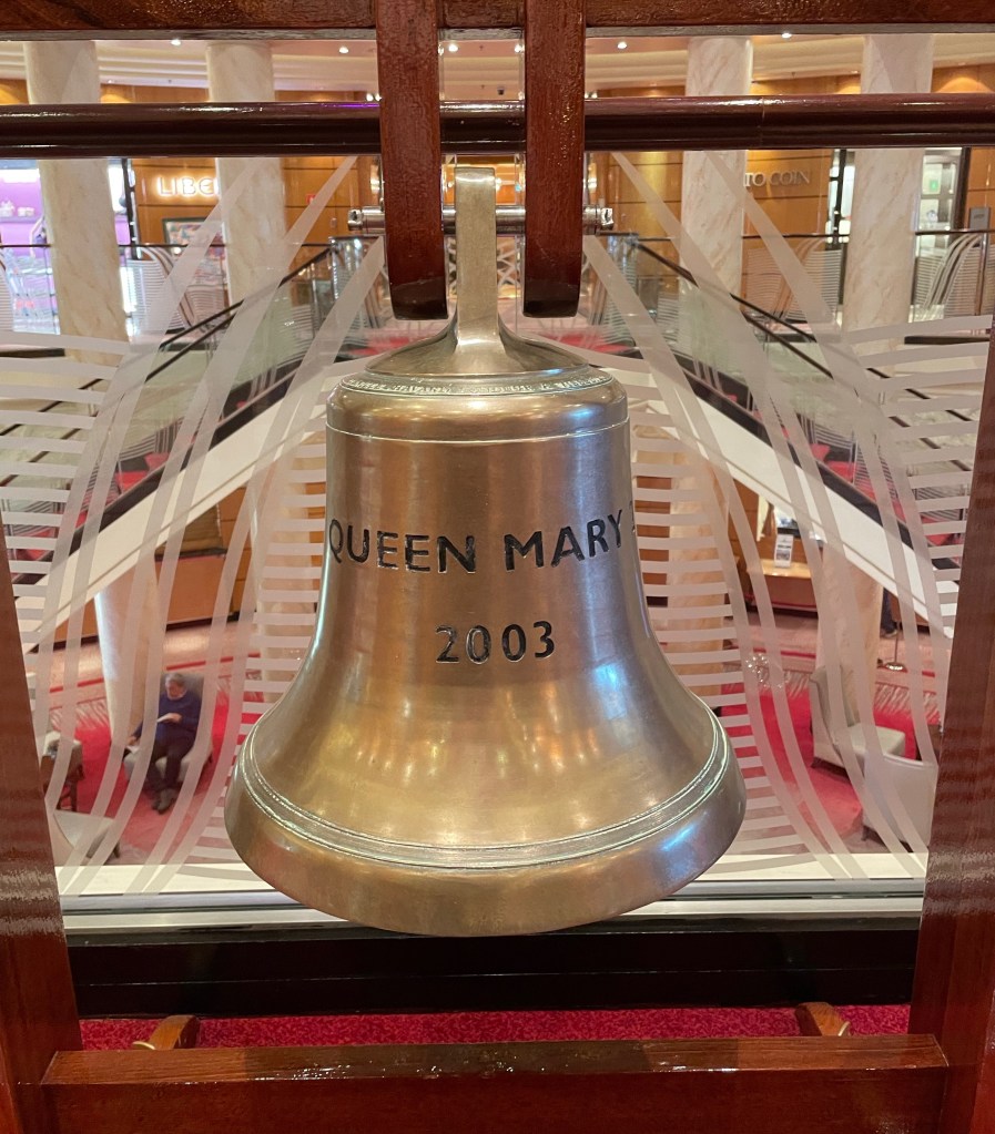 Indoors, a brass bell engraved Queen Mary 2 2003 hangs about a foot off the ground. 